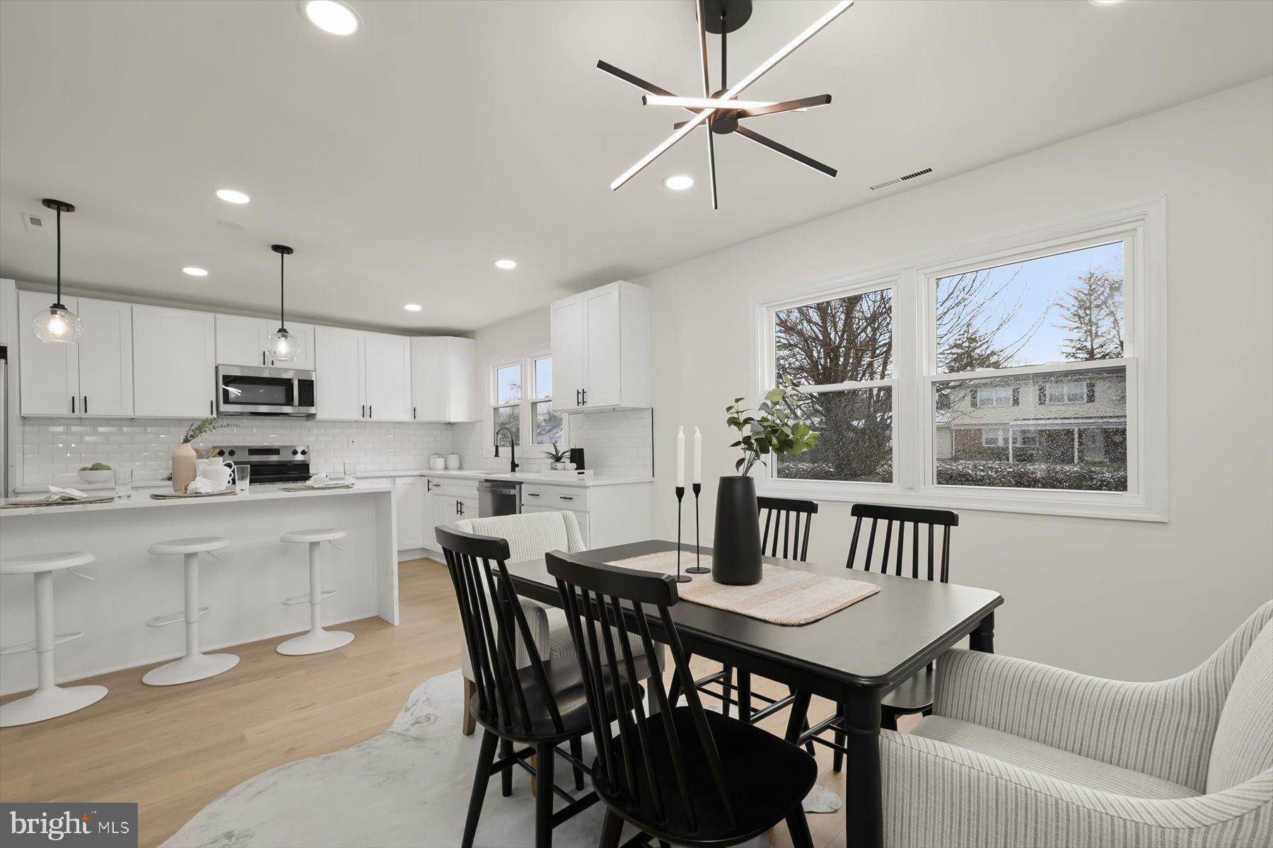 2025 Greengage Road Windsor Mill, MD 21244 - Photo 10 of 28 a kitchen with a dining table chairs stainless steel appliances and cabinets