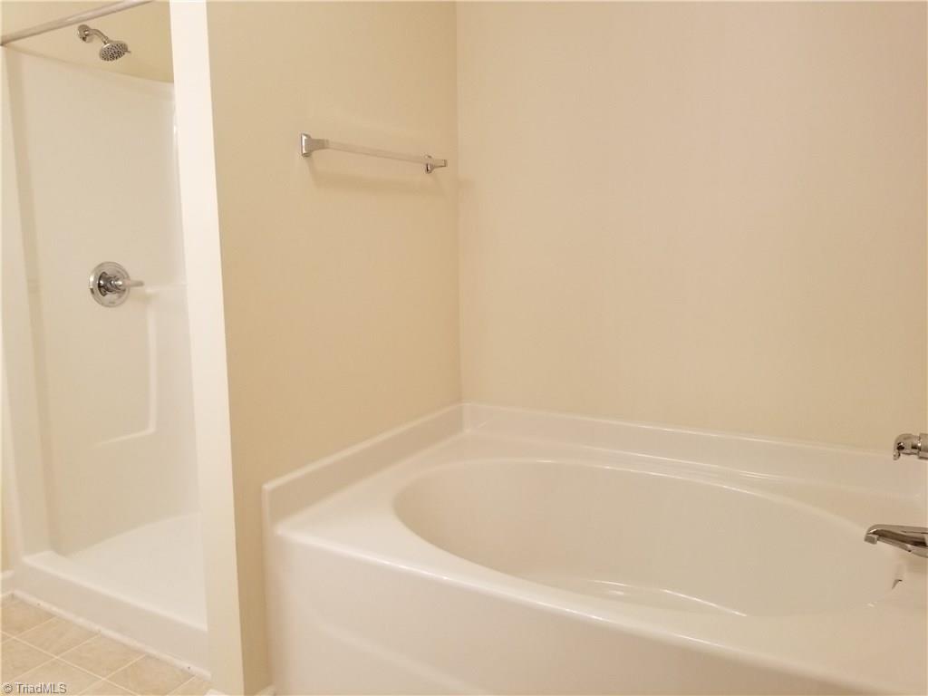 2940 WaterStone Loop High Point, NC 27265 - Photo 5 of 16 The Master Bathroom features a separate garden tub and shower, double sinks, and double sinks and cabinetry.