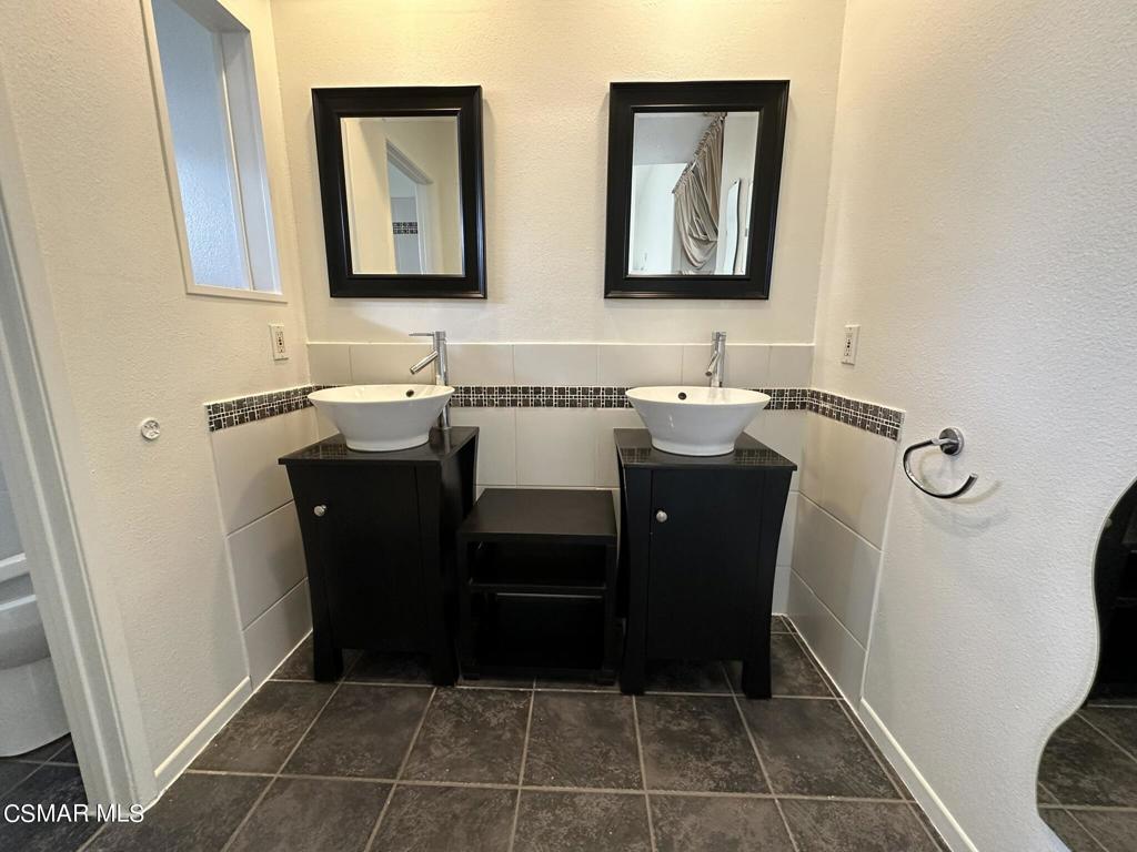 13654 Blacksmith Court Moorpark, CA 93021 - Photo 19 of 34 a bathroom with a sink and a mirror
