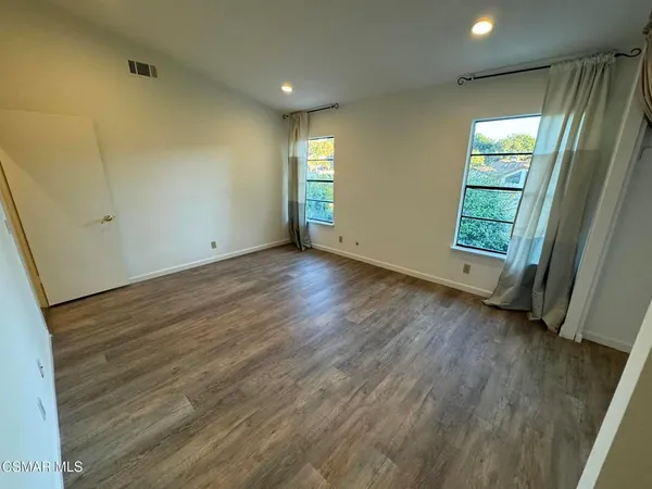 a view of an empty room with a fireplace