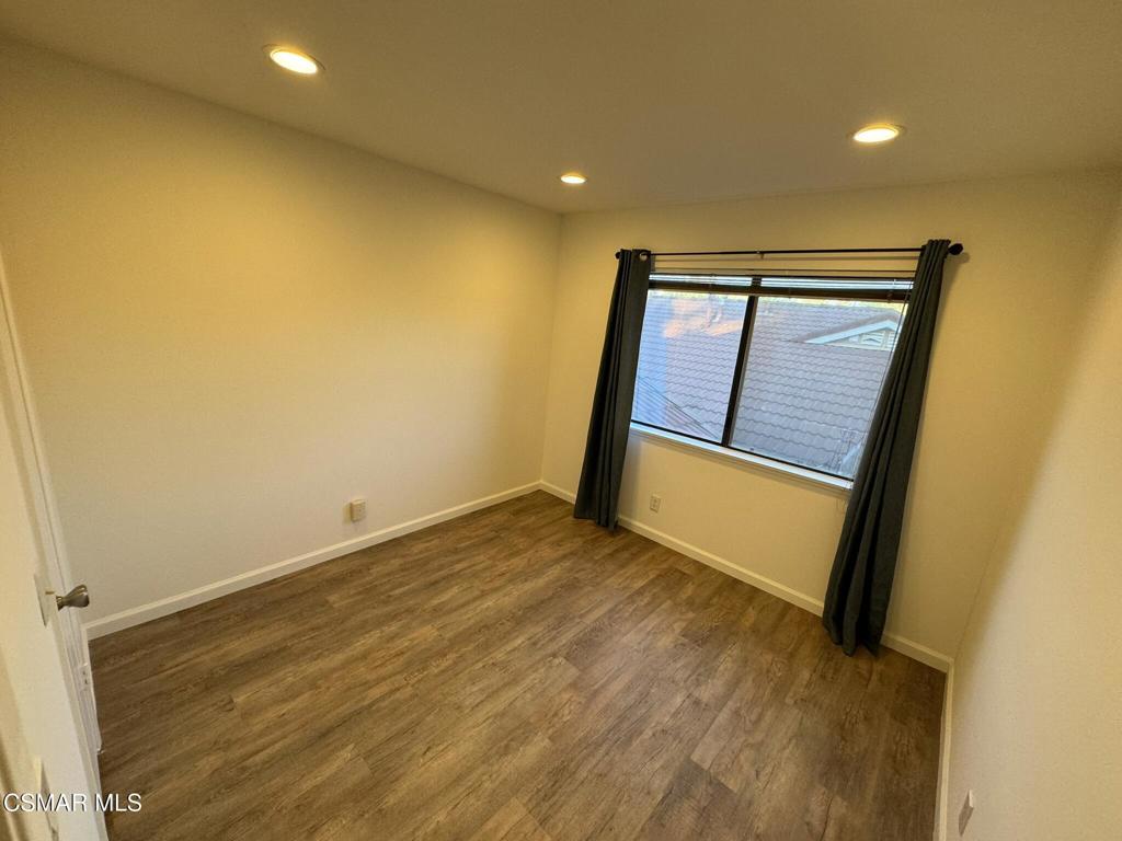 13654 Blacksmith Court Moorpark, CA 93021 - Photo 26 of 34 a view of an empty room with wooden floor and a window