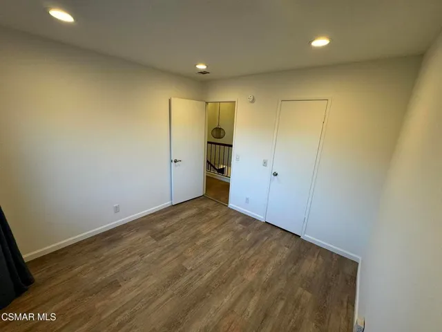 a view of hallway with wooden floor and fence