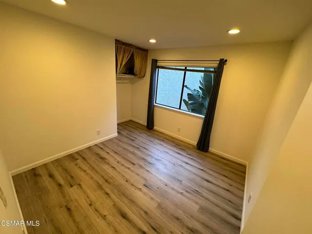 a view of room with wooden floor