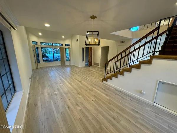 a kitchen with stainless steel appliances granite countertop a refrigerator a sink and a stove