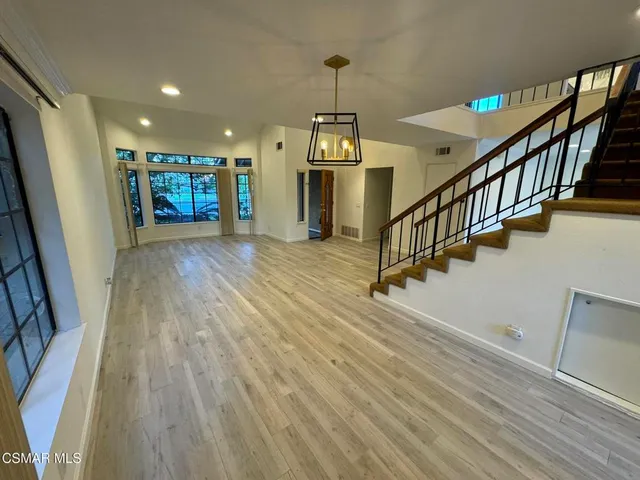 a kitchen with stainless steel appliances granite countertop a refrigerator a sink and a stove