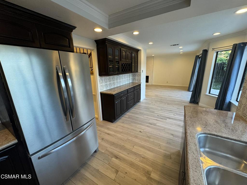 13654 Blacksmith Court Moorpark, CA 93021 - Photo 9 of 34 a kitchen with stainless steel appliances granite countertop a refrigerator a sink and a stove