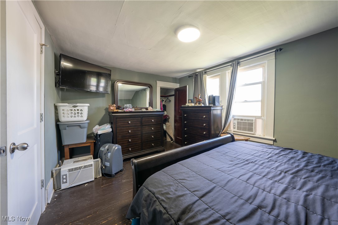 1709 Elm Road Northeast Warren, OH 44483 - Photo 12 of 21 Bedroom with dark wood-type flooring and cooling unit