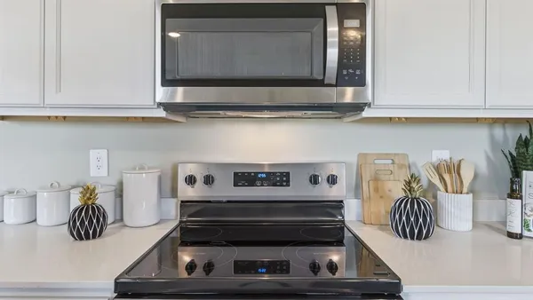 a kitchen with a microwave a stove and cabinets