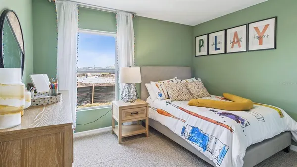 a bedroom with a bed and a dresser