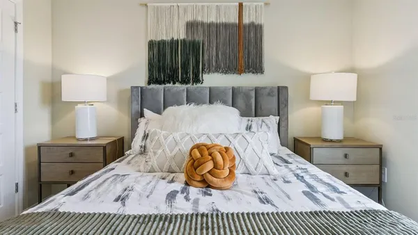 a bedroom with a bed and a lamp