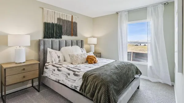 a bedroom with a bed and a mirror