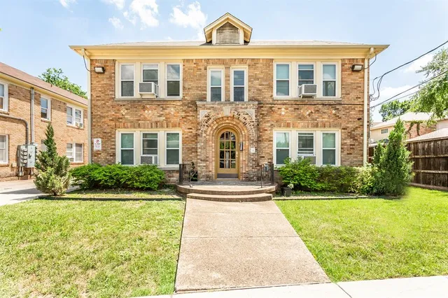 a front view of a building with garden