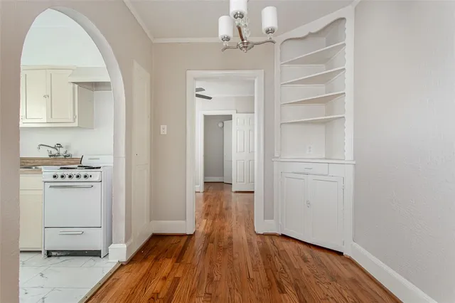 a view of a hallway with wooden floor and closet