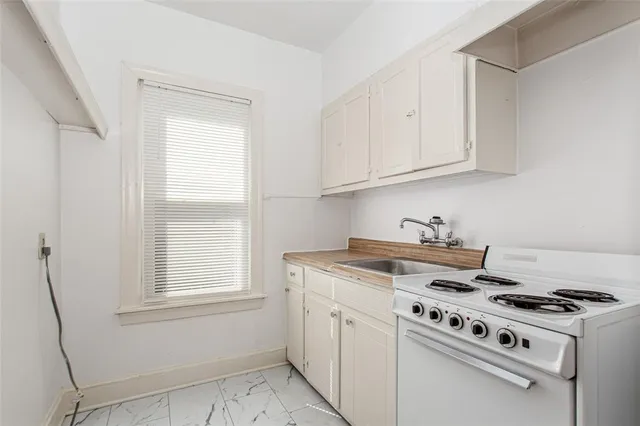 a kitchen with a stove and a window