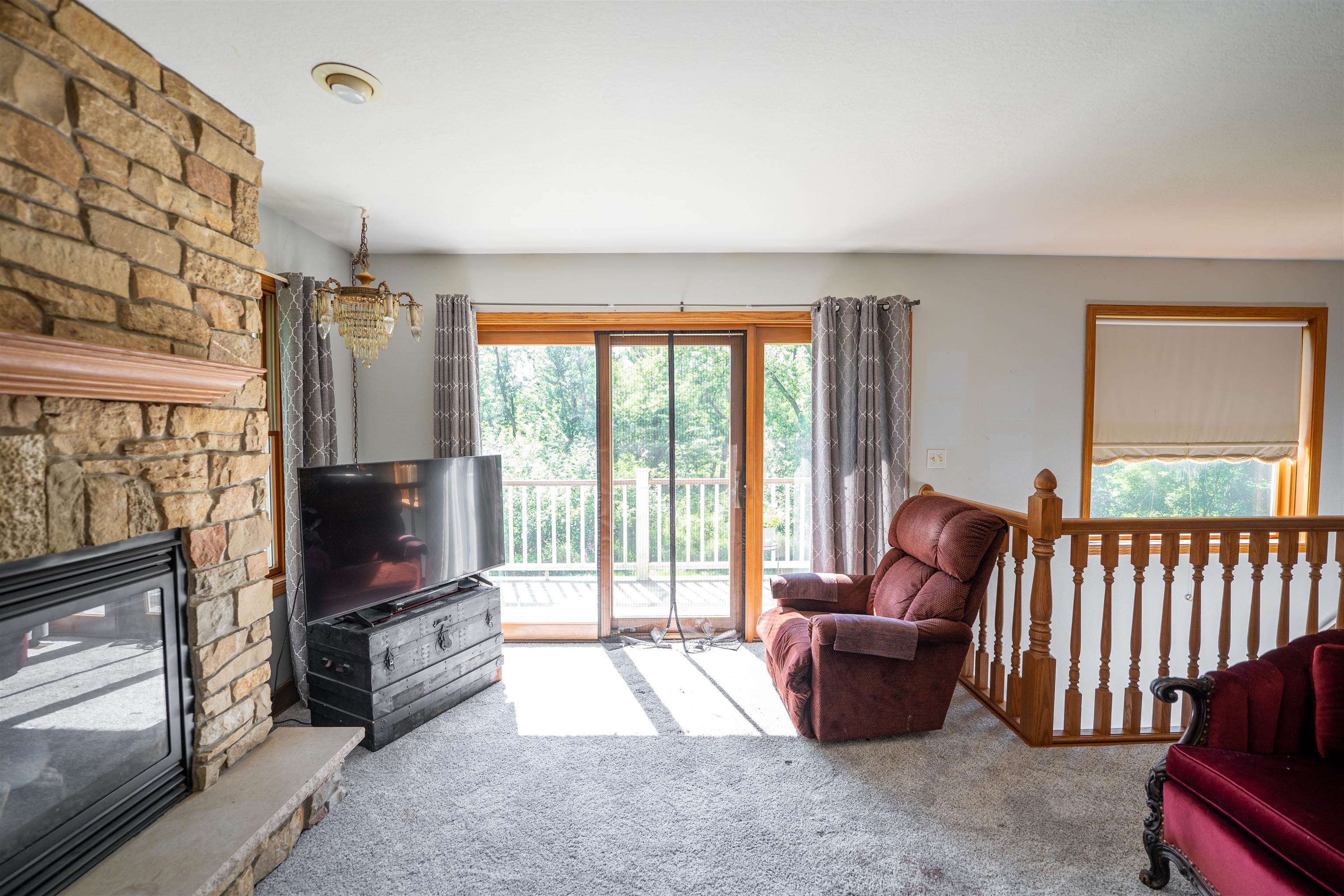 1912 Daysville Road Oregon, IL 61061 - Photo 29 of 74 a living room with furniture a flat screen tv and a floor to ceiling window