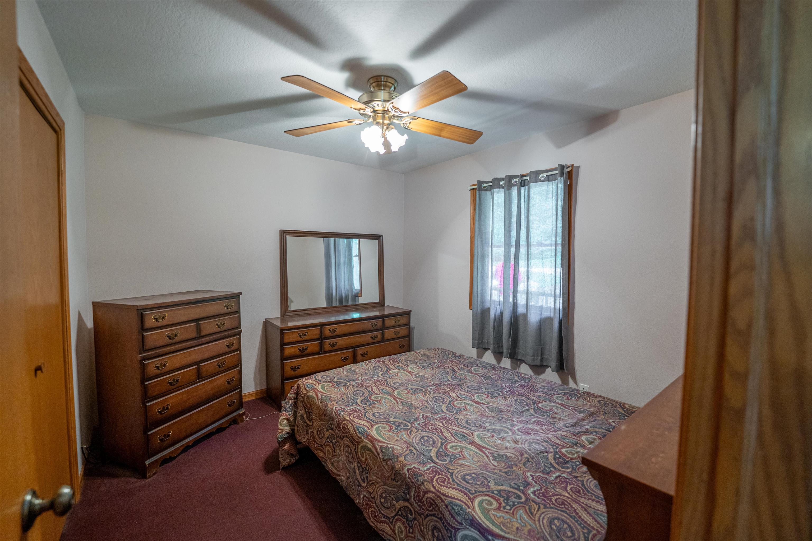 1912 Daysville Road Oregon, IL 61061 - Photo 30 of 74 a bedroom with a bed and a chandelier
