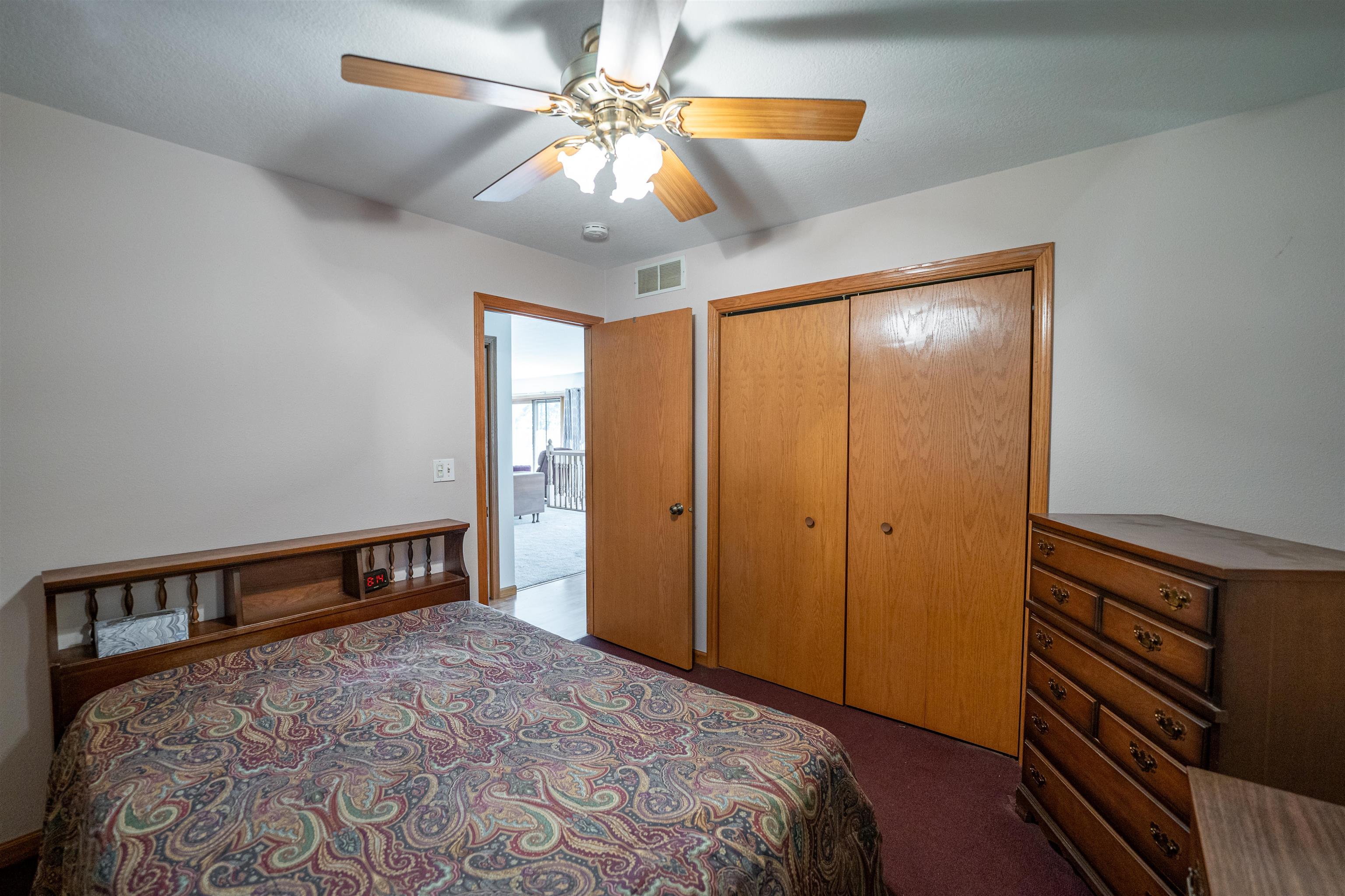1912 Daysville Road Oregon, IL 61061 - Photo 31 of 74 a bedroom with a bed and a chandelier