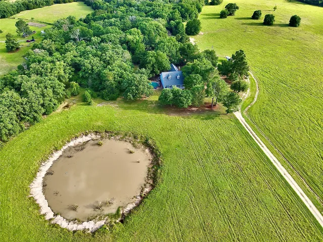 a view of a swimming pool with a yard