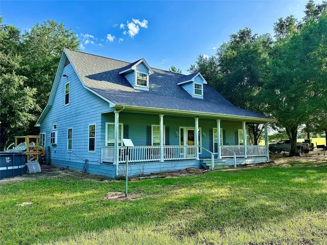 a house view with a seating space and garden