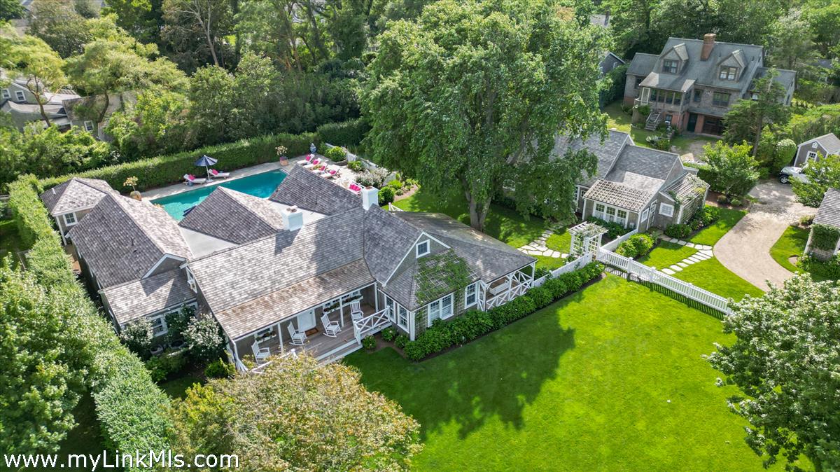 an aerial view of a house with a yard basket ball court and outdoor seating