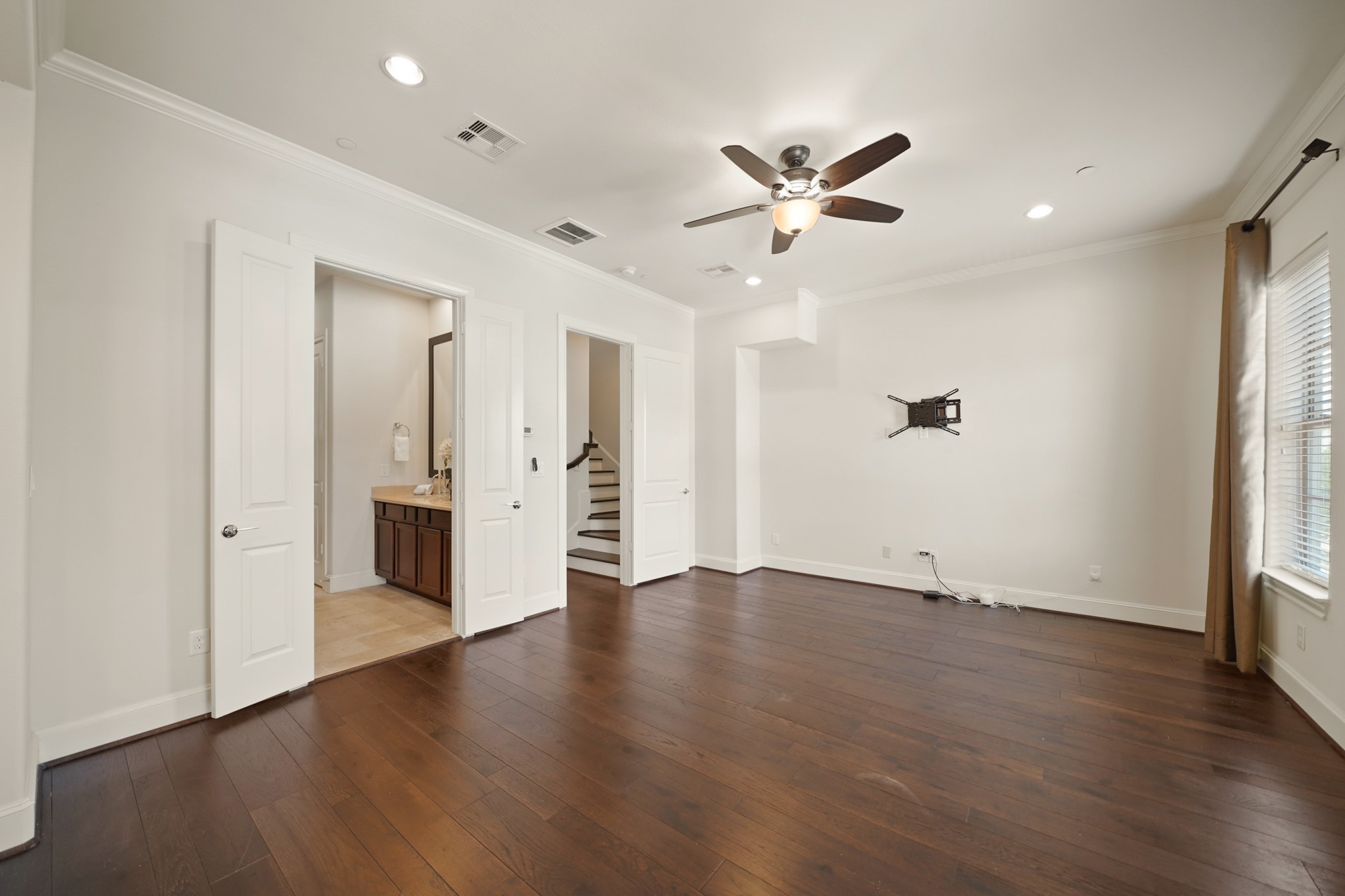 1317 Roy Street Houston, TX 77007 - Photo 21 of 50 Another view of the owner’s suite with double door access to the private bath, recessed lighting and a ceiling fan with light.