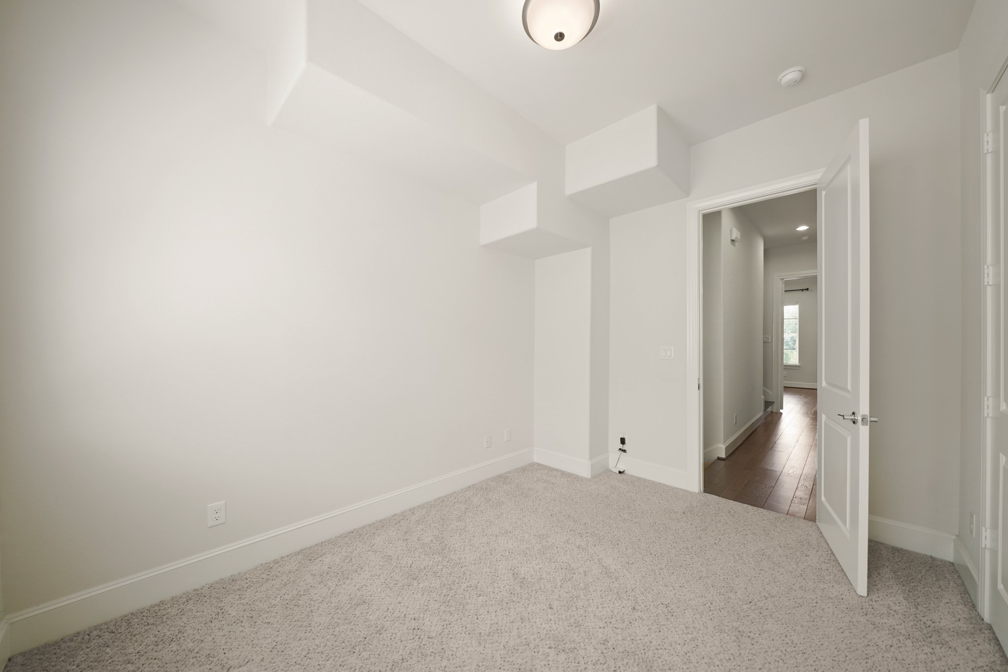 1317 Roy Street Houston, TX 77007 - Photo 28 of 50 Another view of the second bedroom with the utility room and hallway in the background.