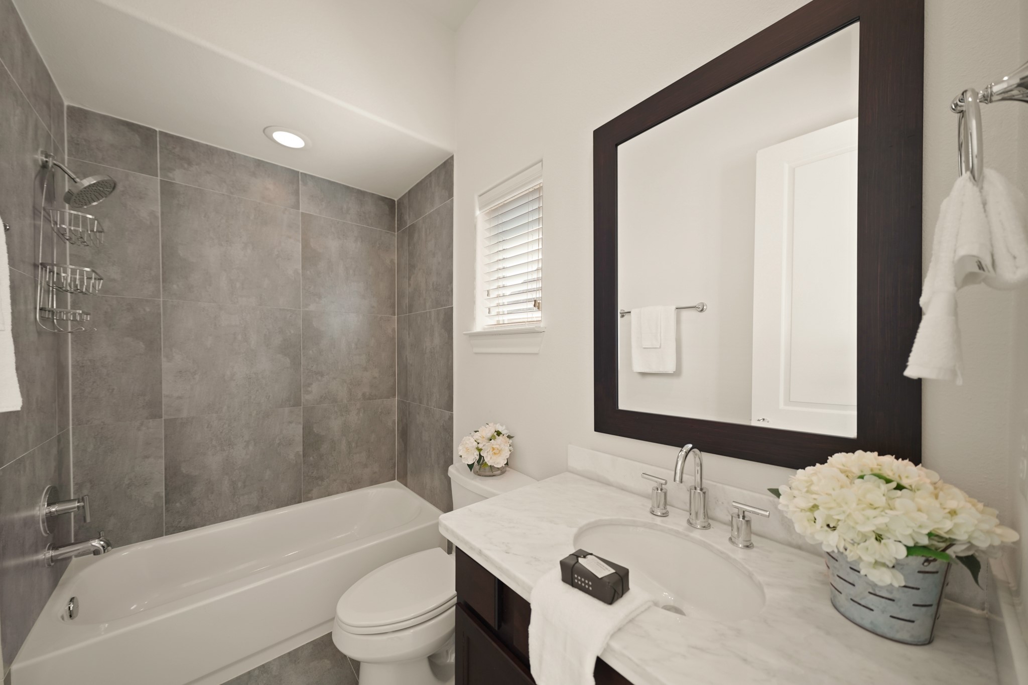 1317 Roy Street Houston, TX 77007 - Photo 30 of 50 The second bathroom has a quartz countertop with chrome fixtures and a framed mirror above.