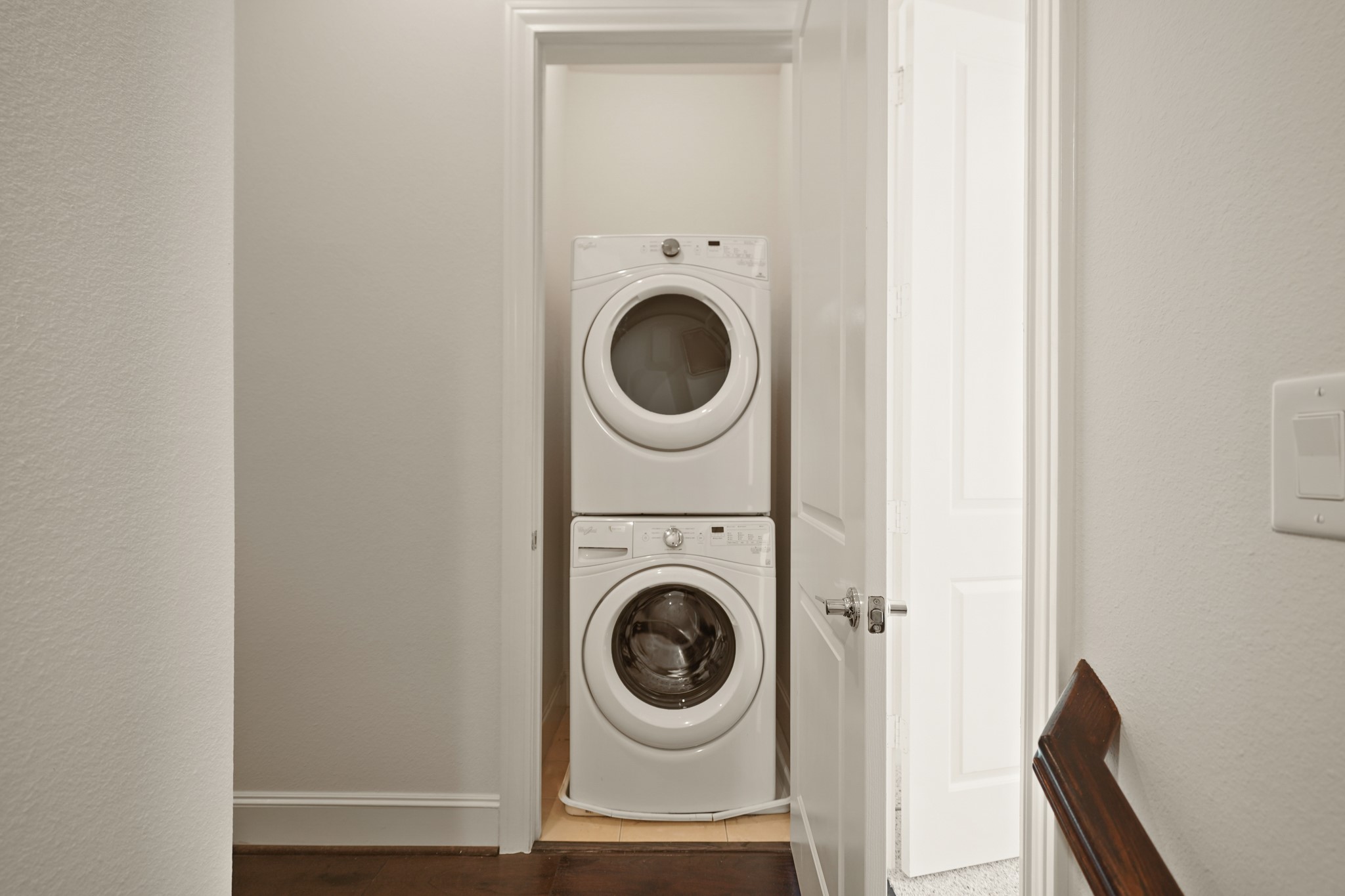 1317 Roy Street Houston, TX 77007 - Photo 32 of 50 The laundry room located in the second floor corridor features a stacked Whirlpool washer and dryer which stays with the home.