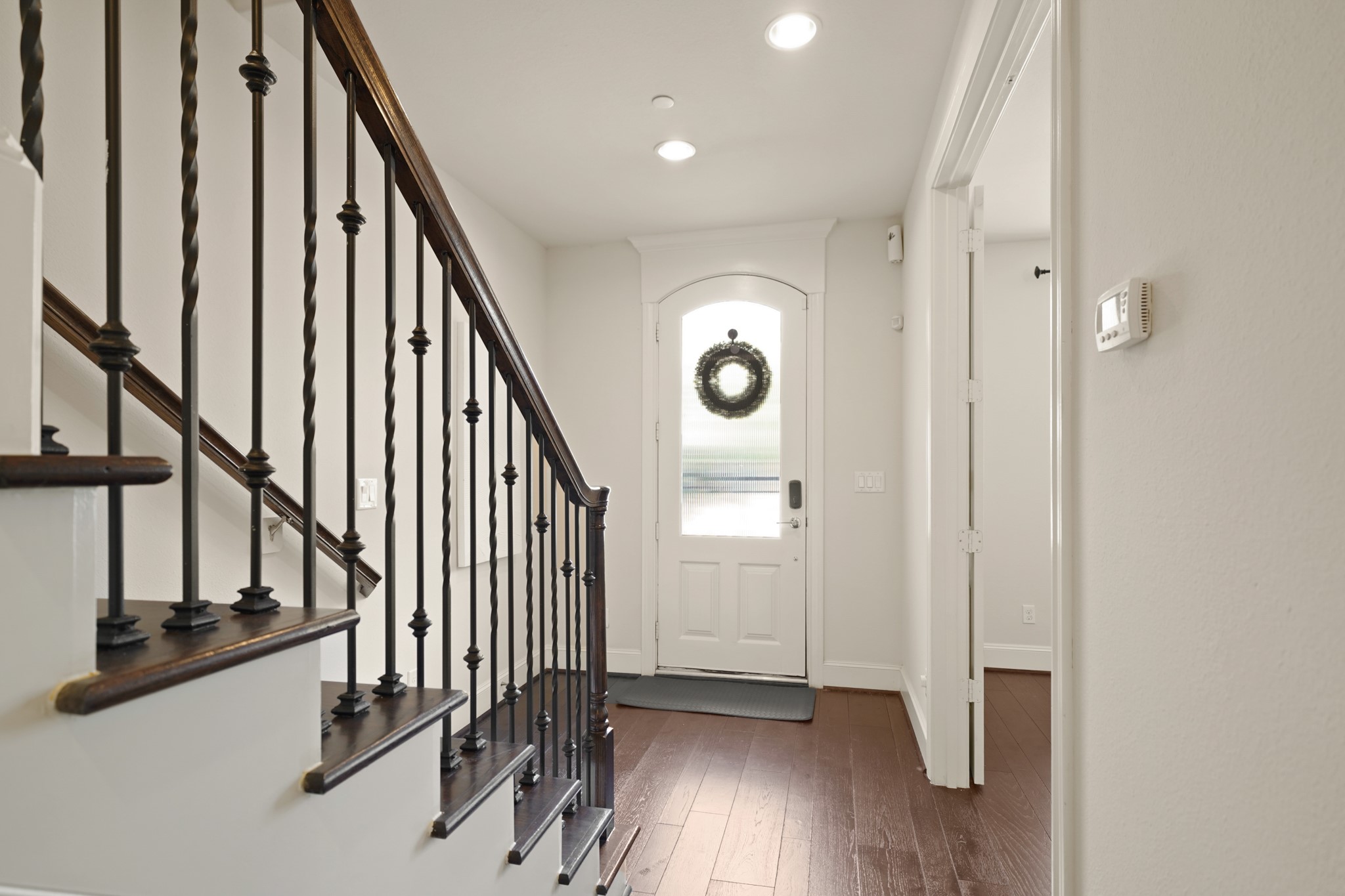 1317 Roy Street Houston, TX 77007 - Photo 4 of 50 The details of the ornamental wrought iron spindles and the wood-tread staircase are on full display in the hallway making everyday movement simple and convenient.