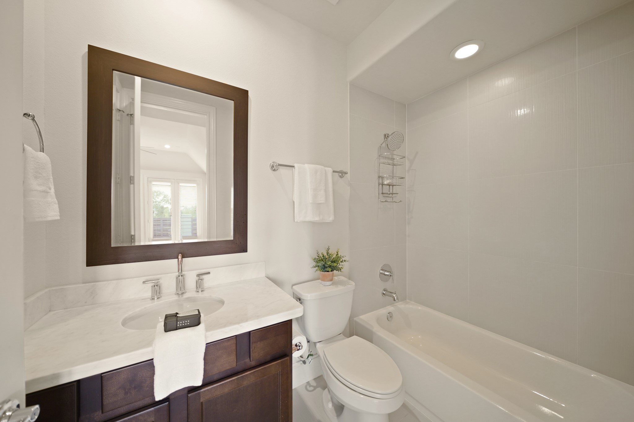 1317 Roy Street Houston, TX 77007 - Photo 40 of 50 The third bathroom features a granite countertop with chrome fixtures and a framed mirror. It offers a tub-shower combination with a tile surround and an oversized showerhead. This bathroom provides convenient access to both the game room and the third bedroom.
