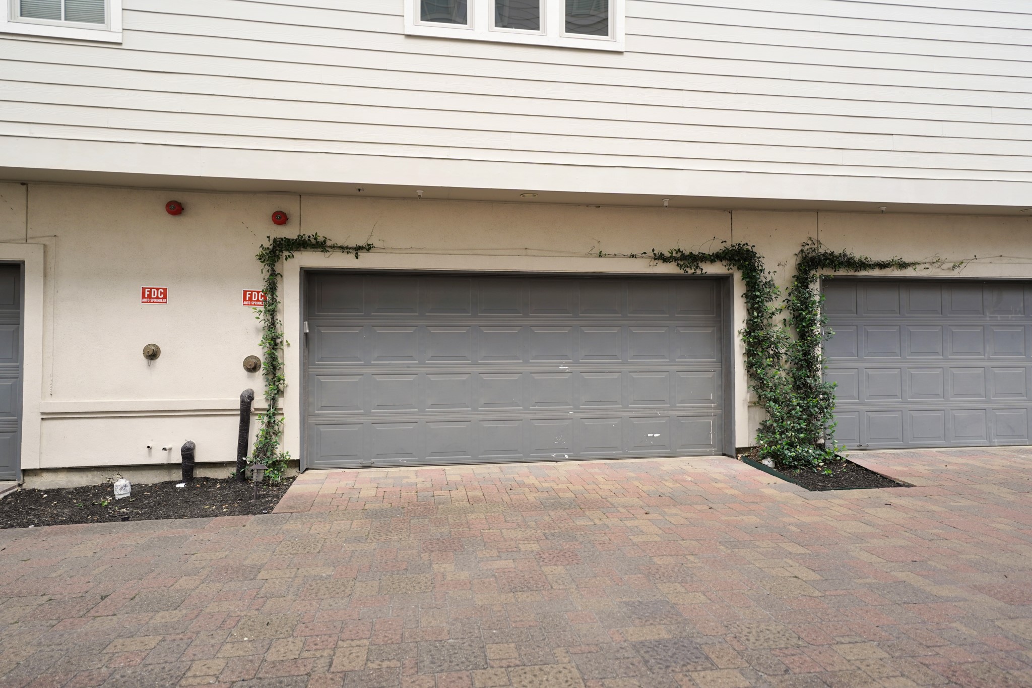 1317 Roy Street Houston, TX 77007 - Photo 48 of 50 The two-car garage is accessed through a gated paved driveway off the back of the home providing added privacy and security. Inside the garage, you'll find a recessed ceiling with overhead lighting and a closet perfect for extra storage.