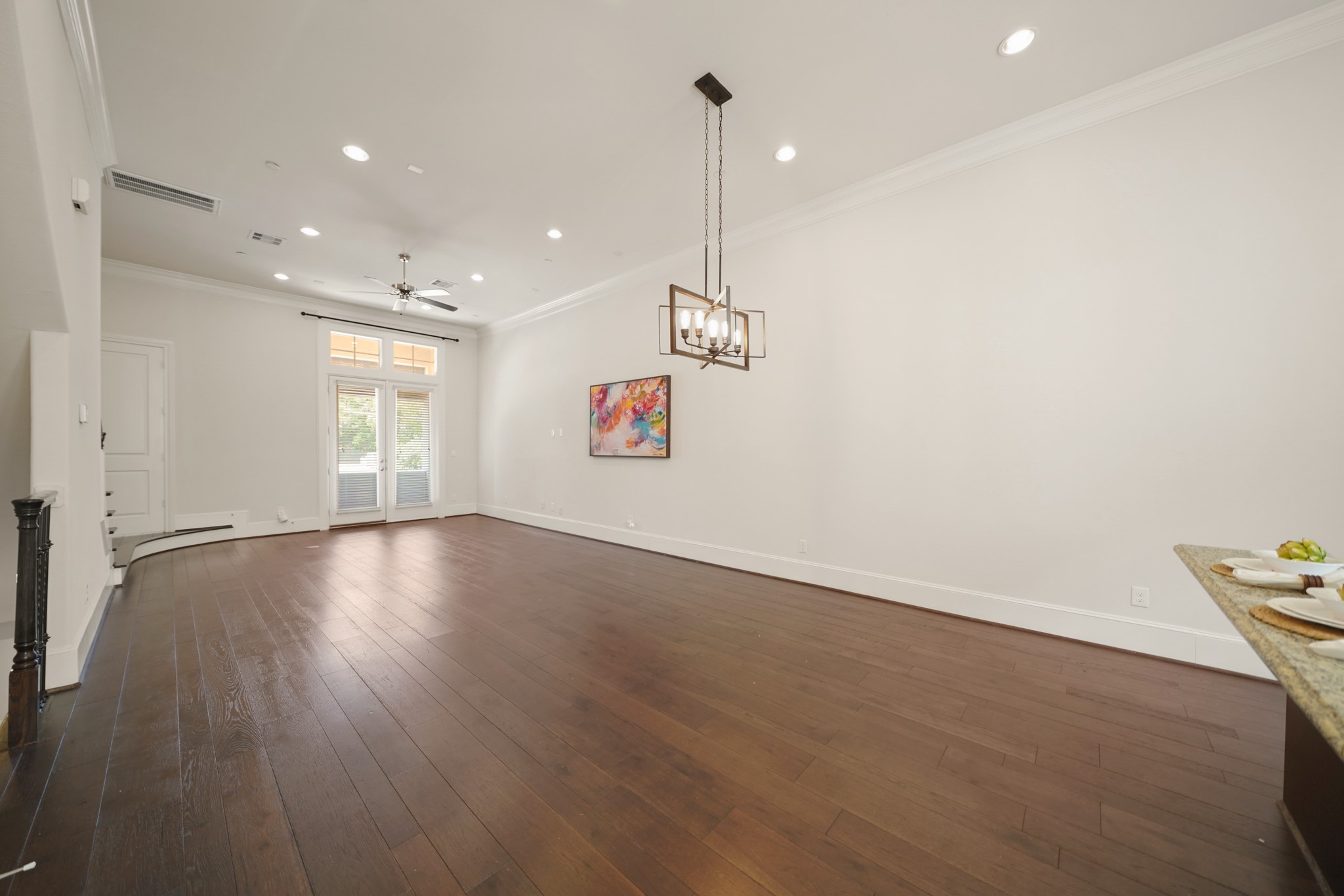 1317 Roy Street Houston, TX 77007 - Photo 5 of 50 With wide-planked hardwood floors throughout, the dining room has a beautiful wrought iron chandelier, double crown moulding and 8-inch baseboards.