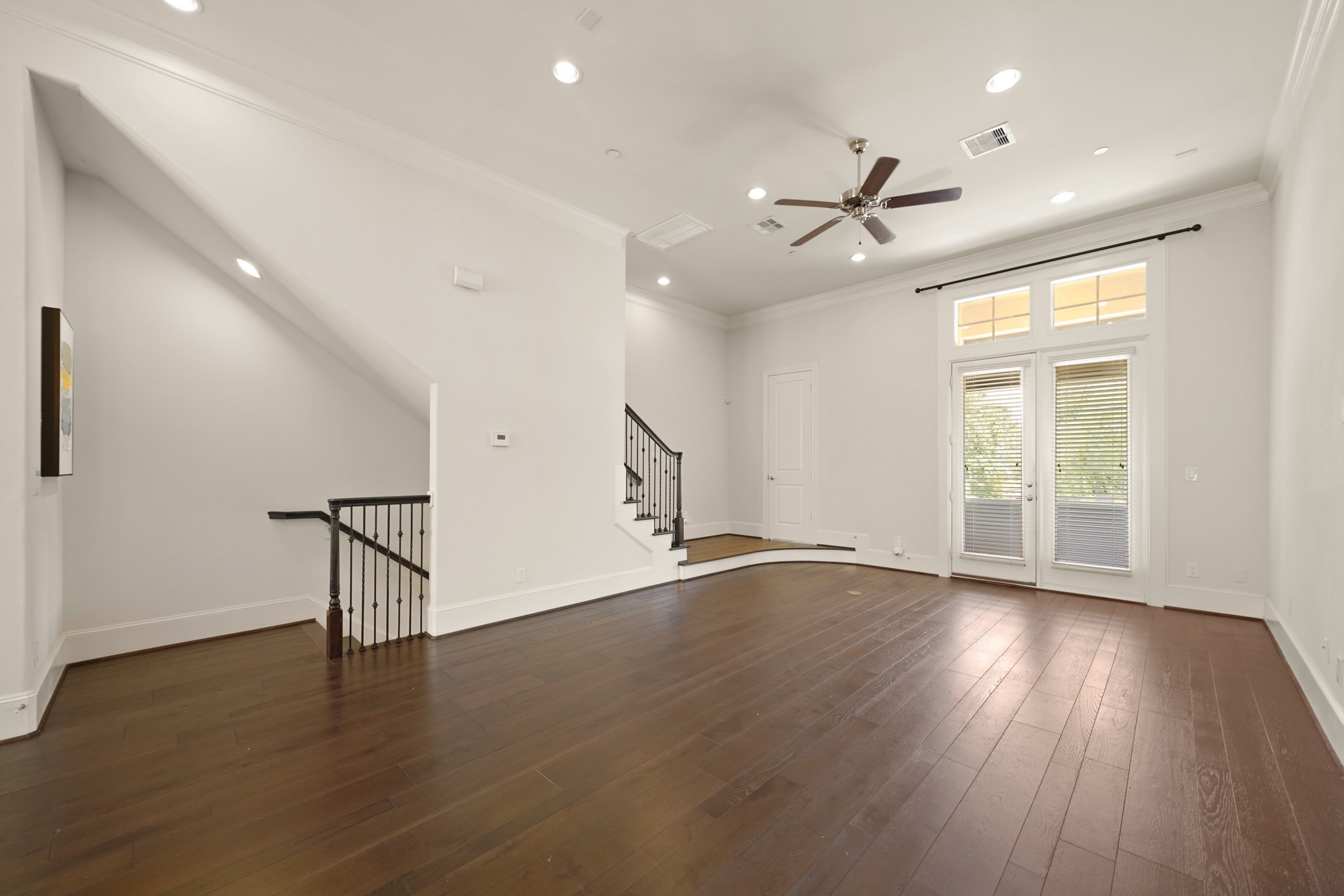 1317 Roy Street Houston, TX 77007 - Photo 9 of 50 A view of the French doors leading to the balcony beyond, while the door on the landing leads to the powder room. Included is a ceiling fan and recessed lighting.