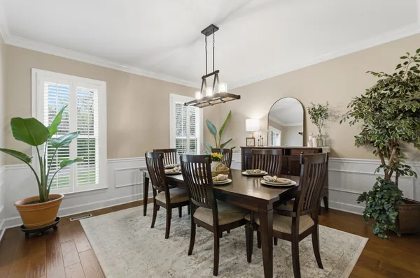 a view of a dining room with furniture window and wooden floor