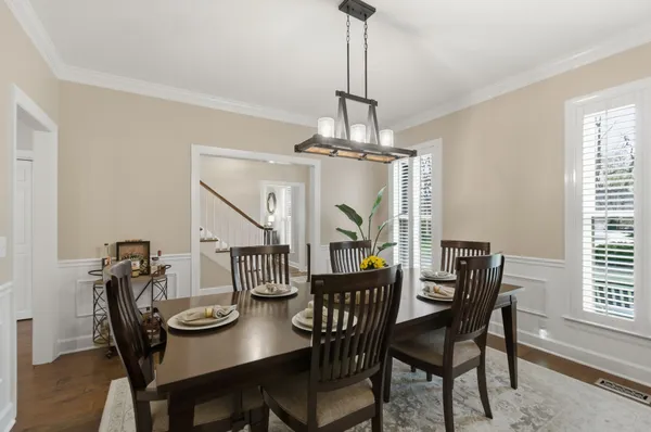 a view of a dining room with furniture window and wooden floor