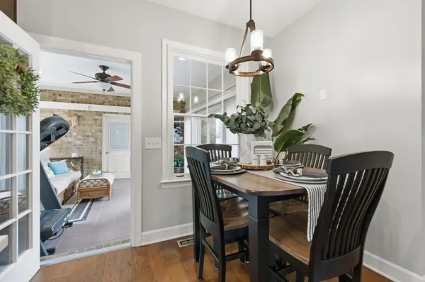 a view of a dining room with furniture and chandelier