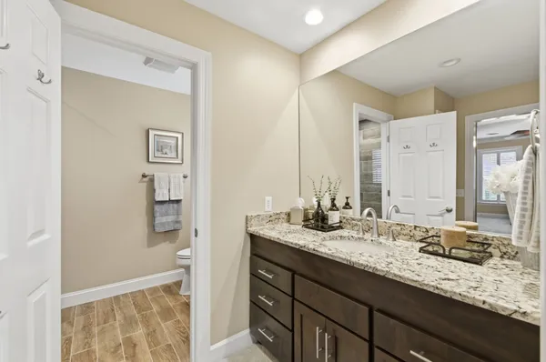 a bathroom with a granite countertop sink and a mirror