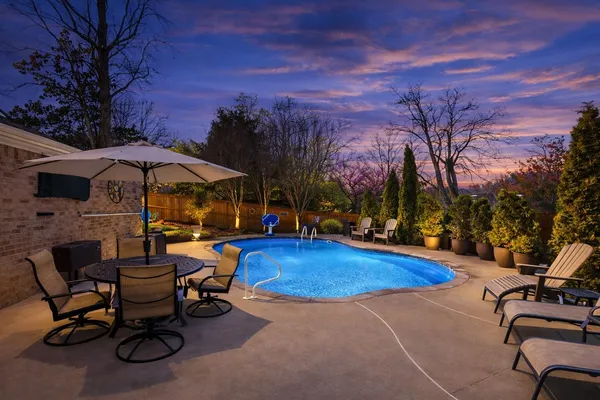 a view of backyard with outdoor seating and trees