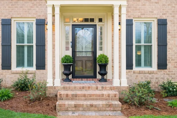 a view of a house with potted plants