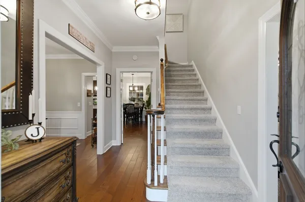 a view of entryway and hall with wooden floor