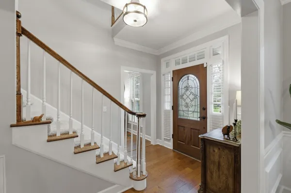 a view of entryway and hall with wooden floor