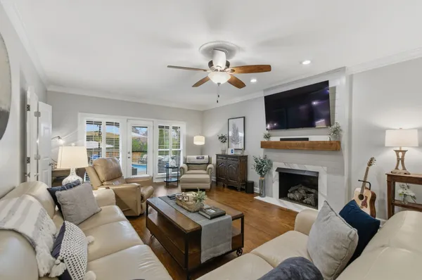 a living room with furniture a fireplace and a flat screen tv