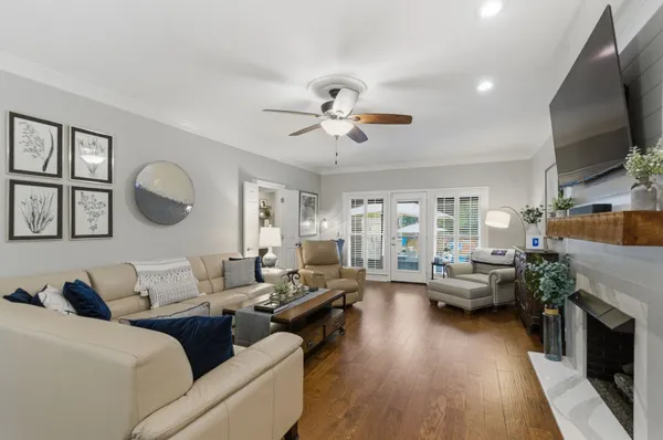 a living room with furniture fireplace and flat screen tv