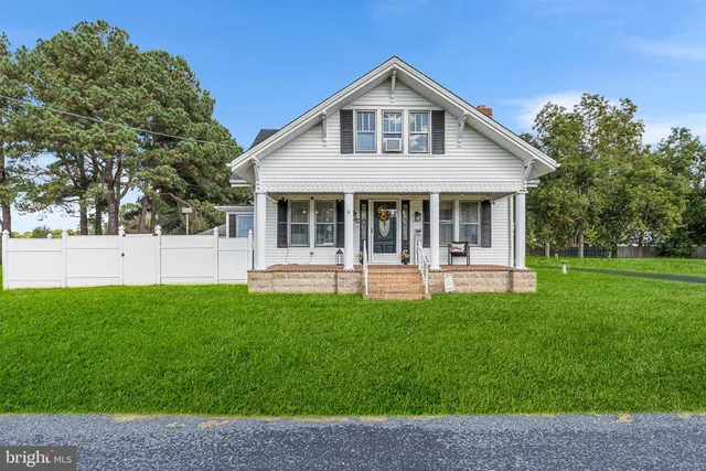 a view of a house with a yard porch and sitting area