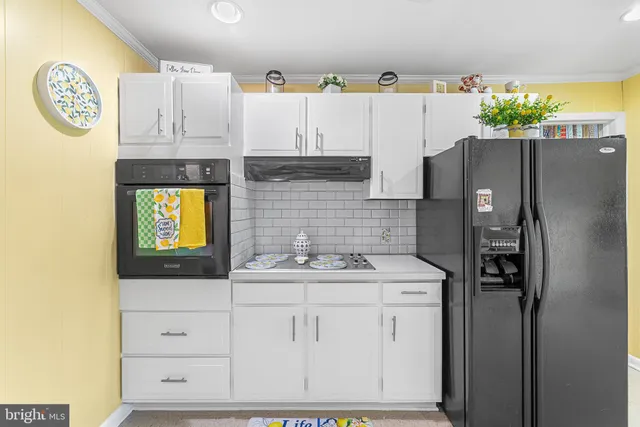 a kitchen with appliances cabinets and a counter top space