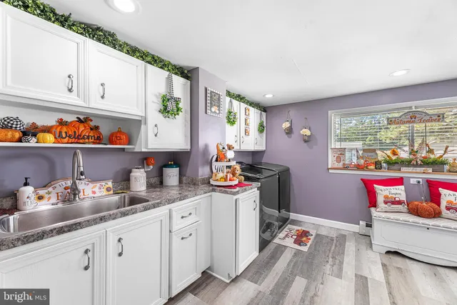 a kitchen with granite countertop a stove and cabinets