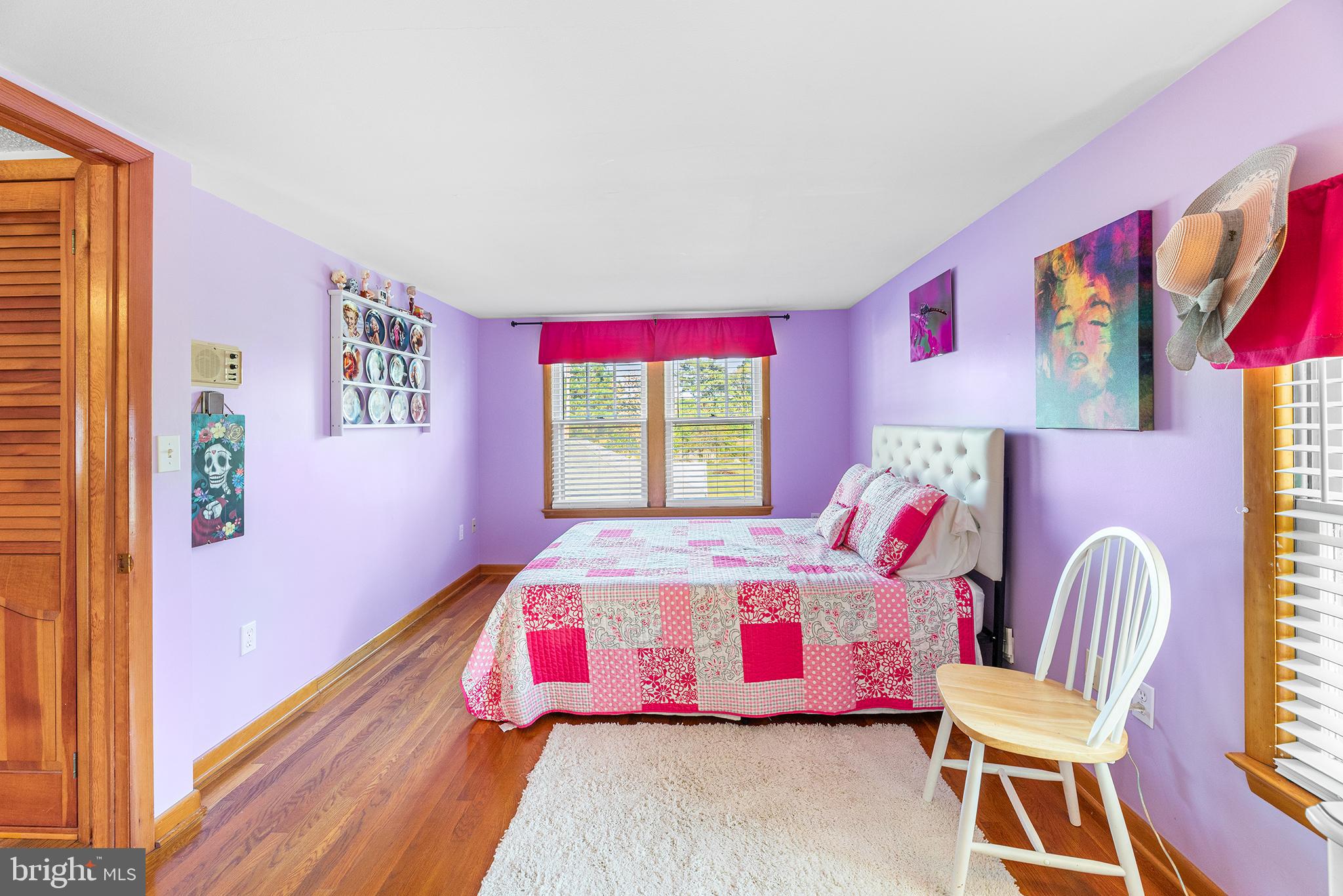 13241 Oyster House Road Princess Anne, MD 21853 - Photo 26 of 39 a bedroom with a bed and wooden floor