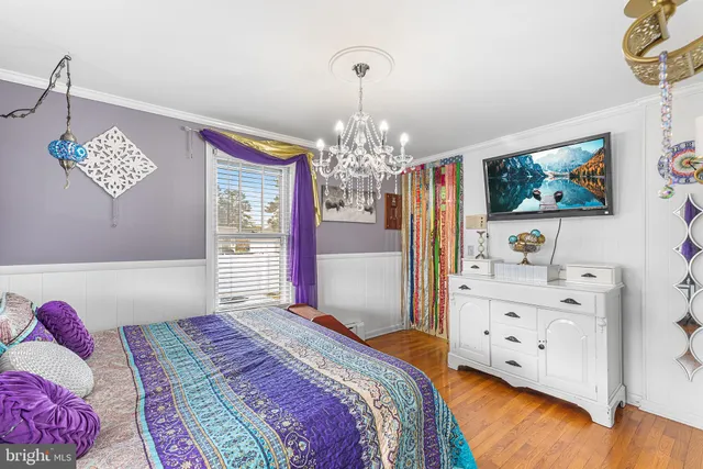 a bedroom with a bed dresser and a window