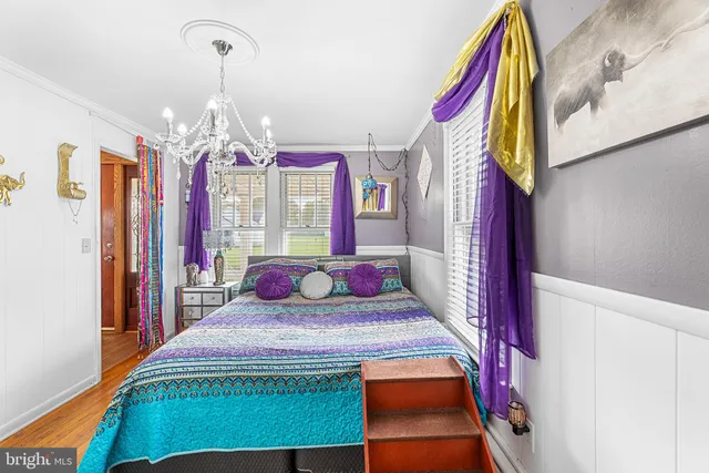 a bedroom with a bed and a chandelier