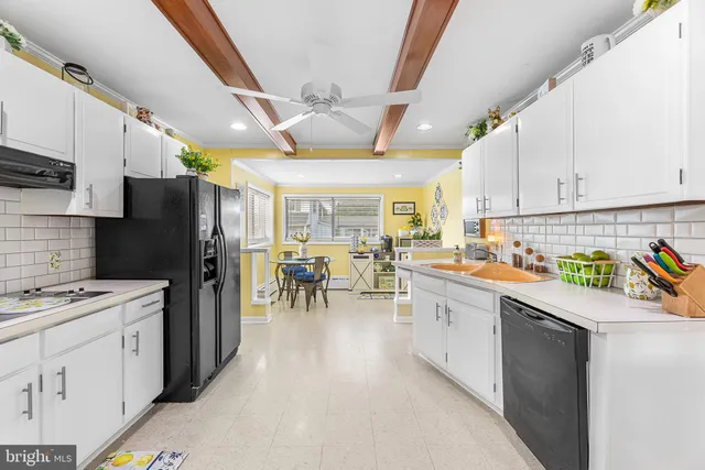 a kitchen with a sink appliances and cabinets
